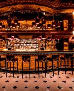 A view of a the golden Wave bar showcasing Park Chinois's luxury style