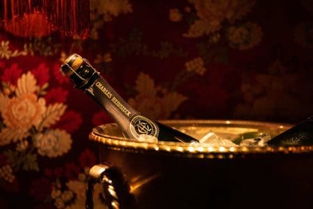 A high-end champagne bottle in gold champagne bucket, in Club Chinois, Mayfair