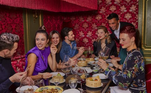 Park Chinois customers dressed fashionably whilst dining, laughing and enjoying Chinese cuisine