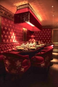 An overview of a group dining table, decorated in rad and gold with Shanghai at its heart