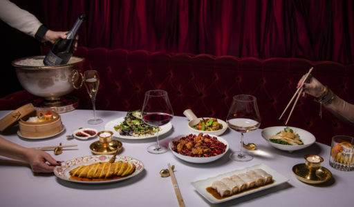Park Chinois dining table setting filled with Chinese for, Champaign and wine