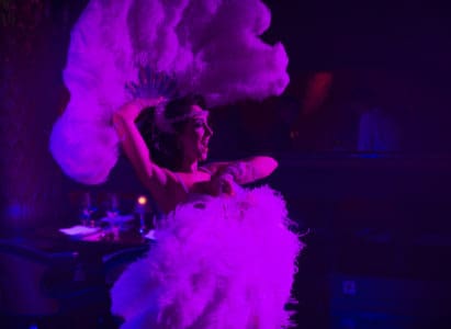 Club Chinois cabaret dancer with two large white feathers